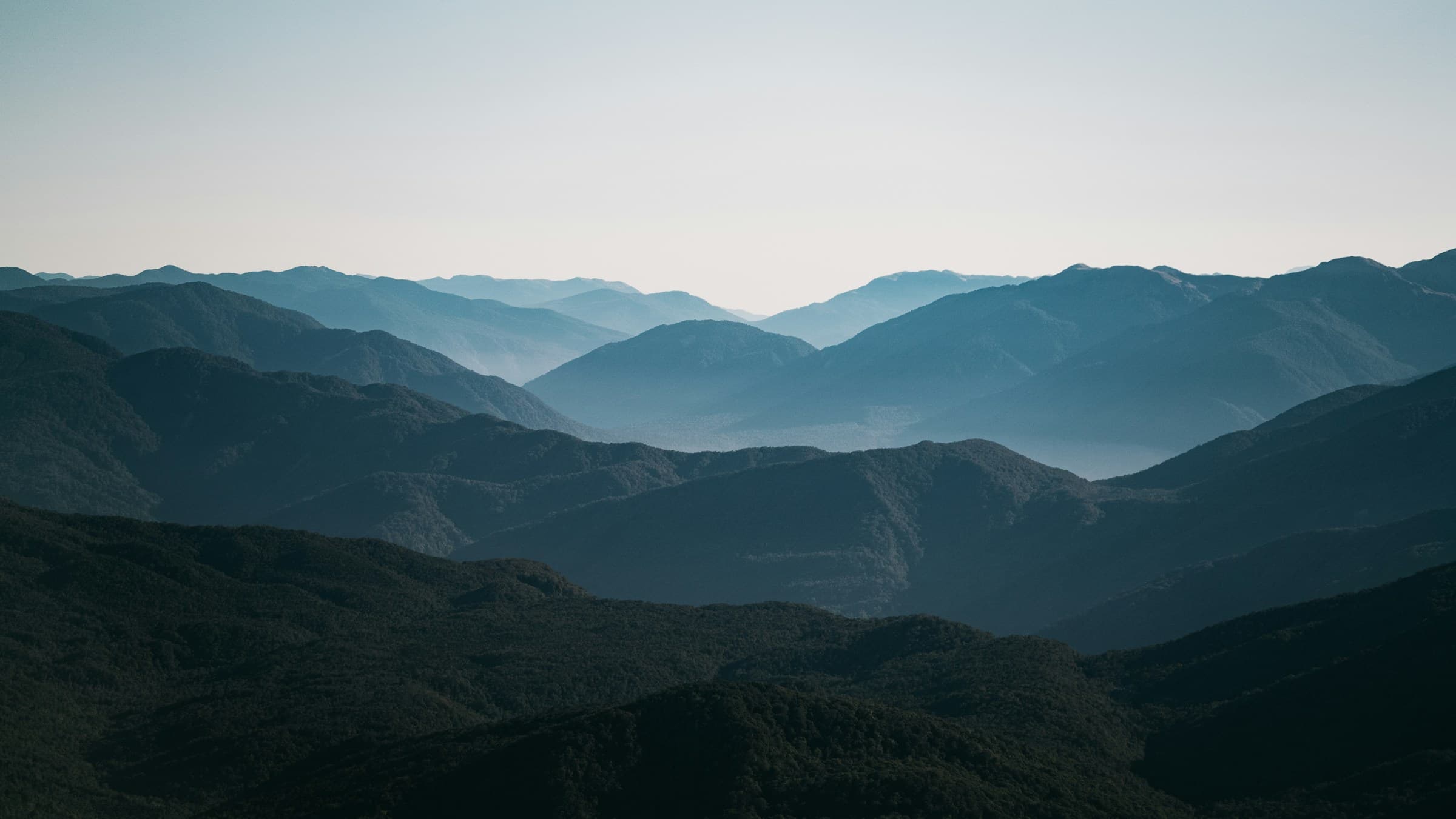 A wide perspective across quiet mountain ridges